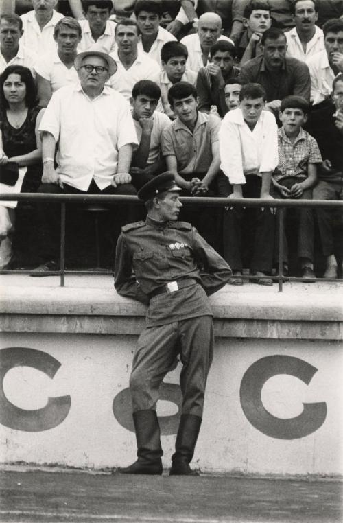 Football match (soldier in front of crowd)