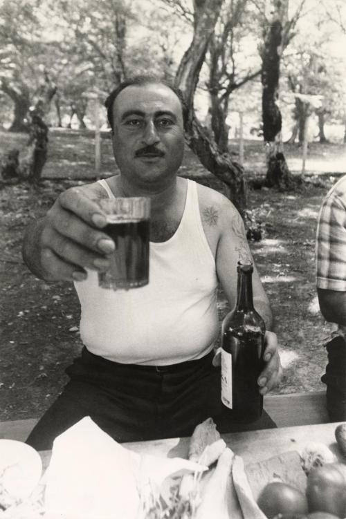 Man offering glass of wine, Kharetie