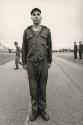 United States Marine Corp boot camp: a recruit that has fallen off a rope is made to stand by himself in front of his buddies, for discipline.