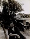 Gypsy woman sitting under a small tree, Saintes Maries de la Mer, France