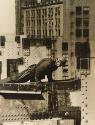 Construction worker climbing over metal beam