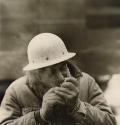 Construction worker lighting up cigarette
