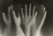 Hands behind textured glass, Japan