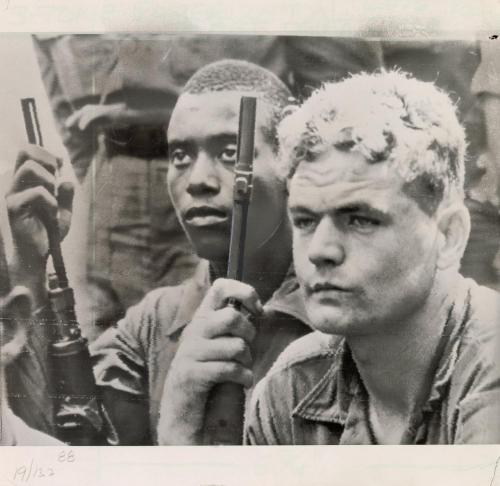 At a memorial service for comrades killed earlier this week in a fierce battle at the Michelin rubber plantation in South Vietnam, two soldiers of the United States 1st infantry division held their weapons as they prayed for the dead
