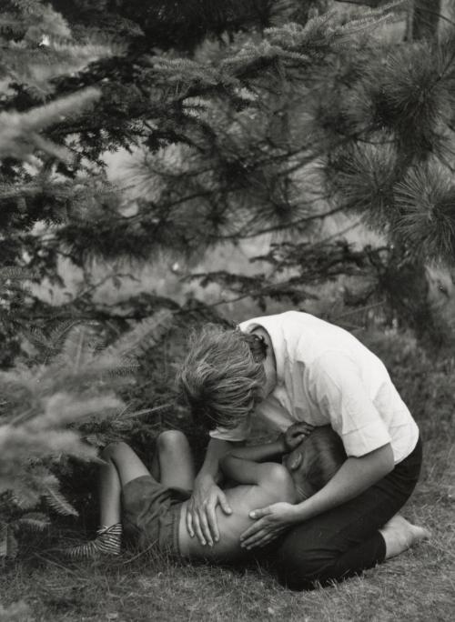 Playing with child under pine trees