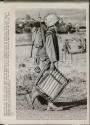 In Full Battle Gear: as he arrives at a staging area at Dong Ha, South Vietnam, a United States Marine carries full battle gear plus a folding chair he scrounged somewhere. The Marine spent a comfortable night in the chair before climbing aboard a helicopter and flying into battle