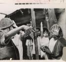 A South Vietnamese soldier guided civilians from areas of street fighting in Southern Da Nang to the relatively safe rear. The homes of the people pictured in Hoa Vang village had been occupied by North Vietnamese troops