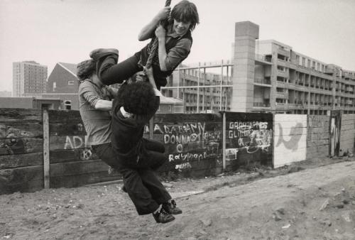 Using the nearby construction area as a playground, these children amuse themselves during school hours instead of attending classes, Manchester, England