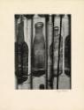 Silhouetted bottles behind curtain