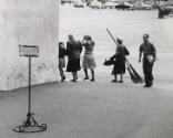 Street scene with man carrying two brooms, Moscow