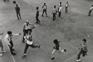 Boys running on basketball court, Havana