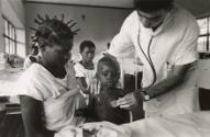 Doctor listening to child's heartbeat, the Democratic Republic of the Congo
