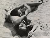 Two girls lying on sand, Coney Island, Brooklyn
