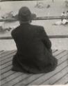 Man sitting on boardwalk, Coney Island, Brooklyn