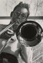 Portait of teenage boy playing trombone (close-up), Indiana