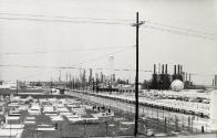 View of graveyard with factory in background