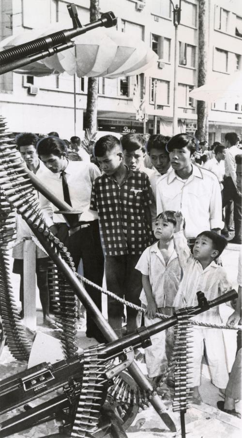 Saigon Citizens look over a displayed of weapons captured form the communists during the Tet offensive