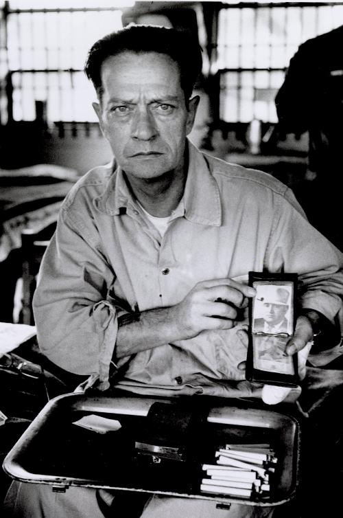 Cummins unit of Arkansas State Penitentiary. The corruption scandal of the historical penitentiary inspired the 1980 film Brubaker, which chronicled the warden's inside investigation into the corrupt southern prison system. The prison raise their own pigs. Close up of a prisoner showing in his wallet the portrait of the former Superintendent O. E. Bishop, Cummins, Arkansas