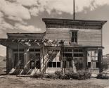 Abandoned building with bushes in front