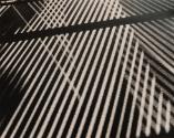 Abstraction of lighting coming through three venetian blinds