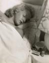 Sleeping woman with teacup and sedative dispenser