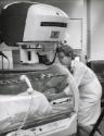 Nurse with patient in scanning machine, likely Canada