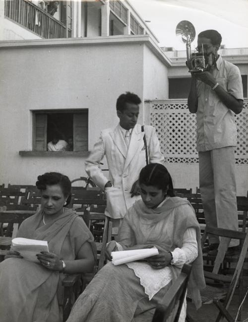 Wealthy woman and young lady seated and having photograph taken, India