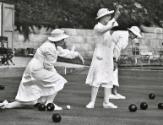 "Near Melbourne, Australia, a woman’s bowling club is holding their Saturday morning tournament. We know the game as Bacci. The object is to get the black balls close to the one white ball."