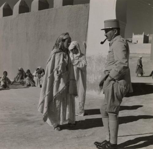 Proconsuls of France: Wide areas of France's African empire are governed practically single-handed by highly capable and experience officers, who are military commanders, administrators, judges and advisors -- all in one. A district so administered is Tinerhir, southeast of Marrakesh, French Morocco. / In the courtyard of his residence, administrator Deal hears the complaint and arbitrates disputes of the natives. Men, women and children alike come to him with all their cares and torubles. He hardly ever fails them, Tinerhir, Morocco