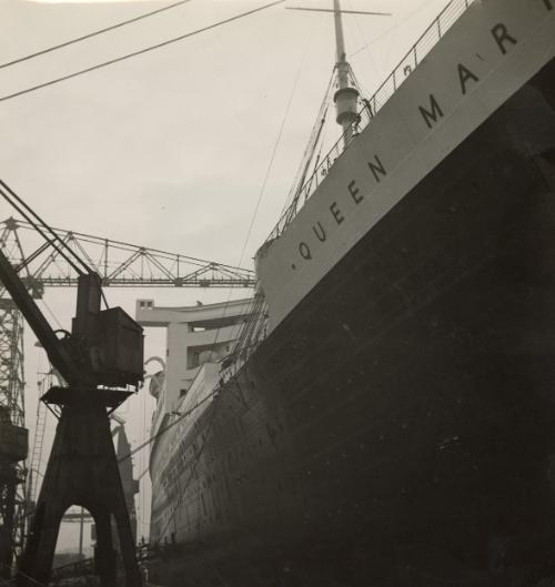 Latest Photos of the "Queen Mary" the largest ship of the world, which will go on her maiden voyage in May. Our photos show different views of the ship, the workers coming and leaving, ropes, chains, etc.