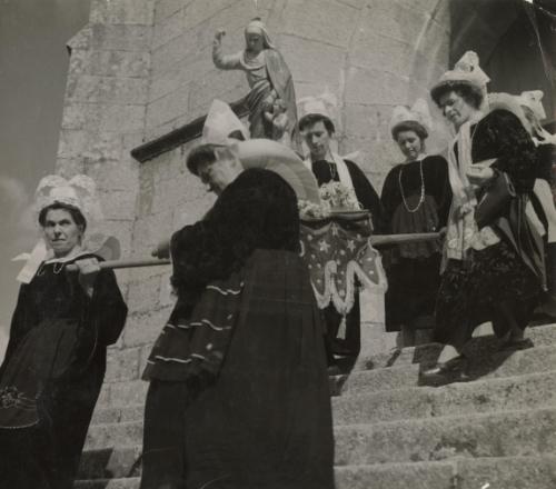 Brittany, France: A Religious Ceremony in the Small Town of Tregunc to which peasant costumes and the beautiful intricate headdress of the women add a colorful note. Pardon a Tregunc (Finistere) statue of the Virgin carried by the faithful during the procession, Brittany, France