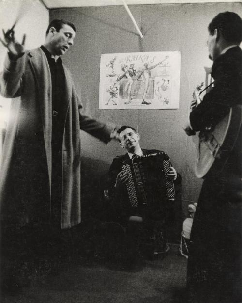 Actor and singer Yves Montand backstage with accordion player and guitarist, from "J'aime le Music-Hall"