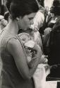Woman giving bottle to infant, March on Washington
