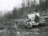 Ollie “Widow” Combs standing next to bulldozer in protest of strip mining on her land