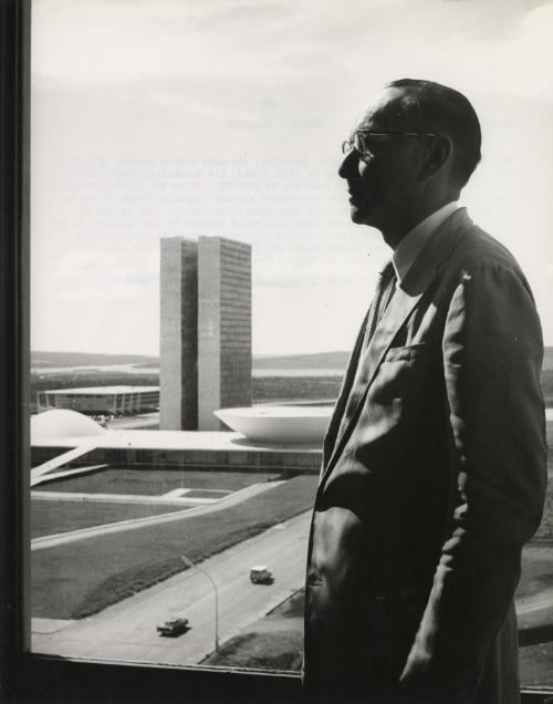 Builders and doctors in Brasilia: Brasilia, the most modern capital city in the world has 65,000 inhabitants in 1959. Today, its population totals 250,000. In three years this figure will increase to 500,000. Since the first foundations were laid, builders and doctors worked closely together, first of all to see to it that the 60,000 workers who took part in building the new city stayed in good health, then to prevent the town from being invaded by the diseases of bush and forest. Immigrants' health is checked systematically on the road into Brasilia, while specialists study the flora and fauna of the environment in order to discover possible sources of dangerous diseases. Dr. Cattete Pinheiro, Brazilian Minister of Health, at the window of his office.