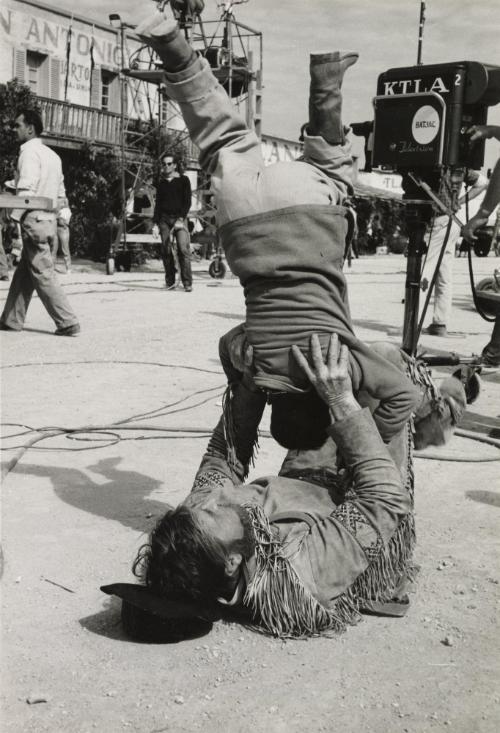 Actor playing with child on the set of "The Alamo"