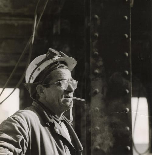 Construction worker in glasses and with cigarette in mouth