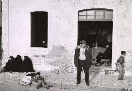 Villagers in front of a storefront, Portugal