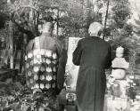 Two men praying at grave