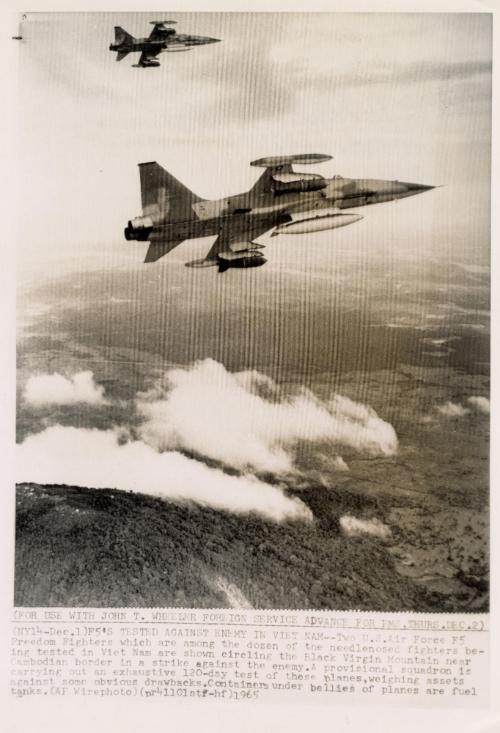 F5's Tested Against Enemy in Vietnam: two US Air Force F5 Freedom Fighters which are among the dozen of the needle-nosed fighters being tested in Vietnam are shown circling the Black Virgin Mountain near Cambodian border in a strike against the enemy.  A provisional squadron is carrying out an exhaustive 120-day test of these planes, weighing assets against some obvious drawbacks. Containers under bellies of planes are fuel tanks