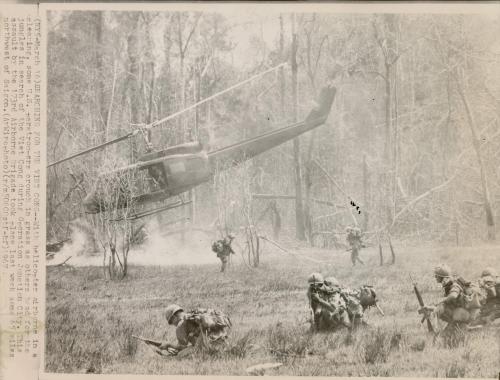 Searching for the Viet Cong: with helicopter airborne in a clearing, some US paratroopers crouch in grass as others head for the jungles in search of the Viet Cong during Operation Junction City. This assault by the 173rd Airborne Brigade took place last week some 65 miles northwest of Saigon