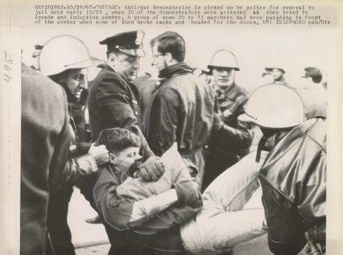 Anti-war demonstrator is picked up by police for removal to jail here early today when 20 of the demonstrators were arrested as they tried to invade an induction center. A group of some 50 to 75 marchers had been parading in front of the center when some of them broke ranks and headed for the doors