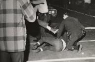 A demonstrator kicks out at a policeman as he is being arrested on the Near North Side