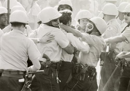 Chicago police take charge of a heckler as civil rights marchers leave Cicero and re-enter Chicago, Illinois.