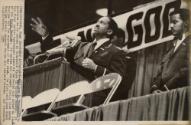 First  Appearance: Wallace D. Muhammad, gestures as he speaks at McCormick Place in Chicago Sunday. It is his first public appearance since he succeeded his father a leader of the Black Muslims. He called for stronger family ties among Muslims and for supremacy of the mind. He also said that Black Muslims should respect whites who respect blacks.