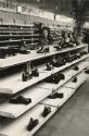 Man behind shoe display, Warsaw, Poland