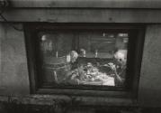 View through window of old couple seated at table