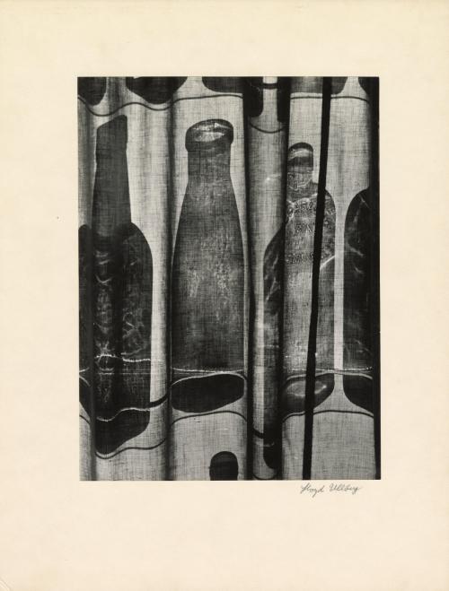 Silhouetted bottles behind curtain