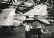 Scientist with spacecraft in the background at McDonnell Aircraft Corporation working for NASA's second human spaceflight program, Project Gemini, St. Louis, Missouri