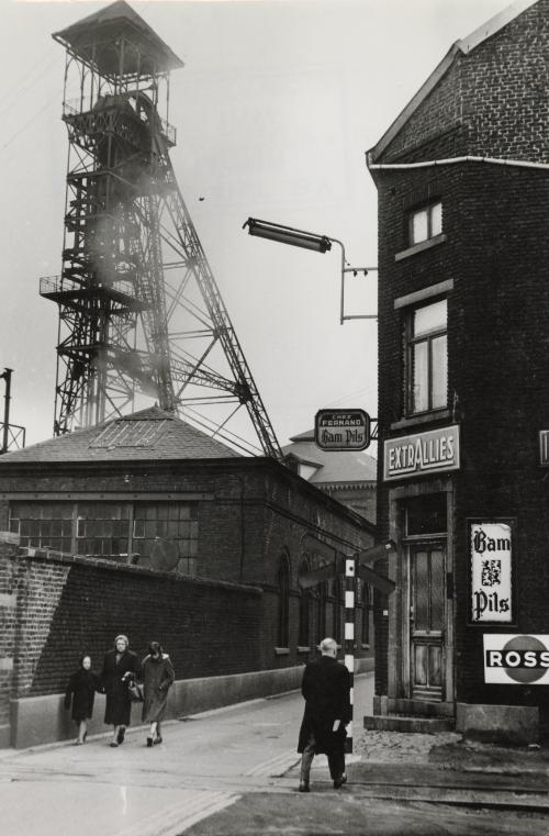 Street scene with man walking into corner store, Charleroi, Belgium